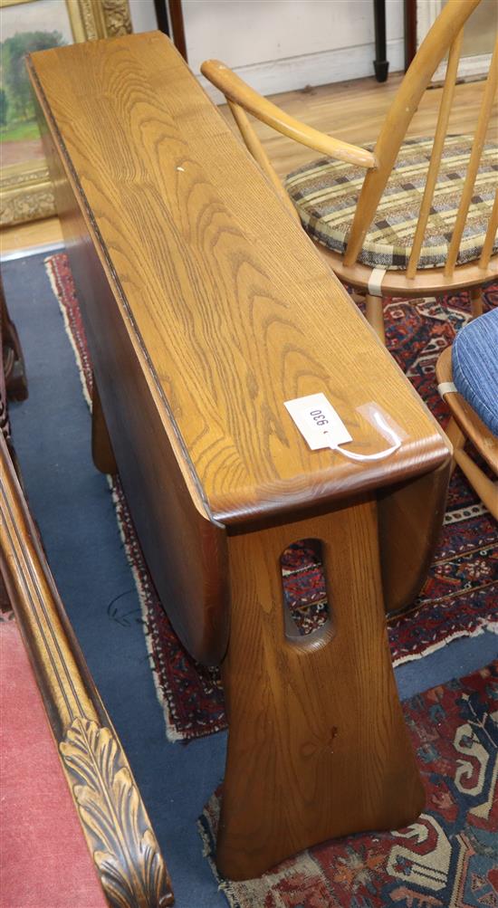 An Ercol elm drop leaf dining table W.107cm